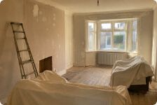 A room with dust sheets and a stepladder, ready for a first visit